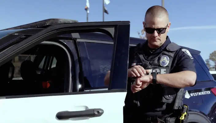 police officer standing outside of his car